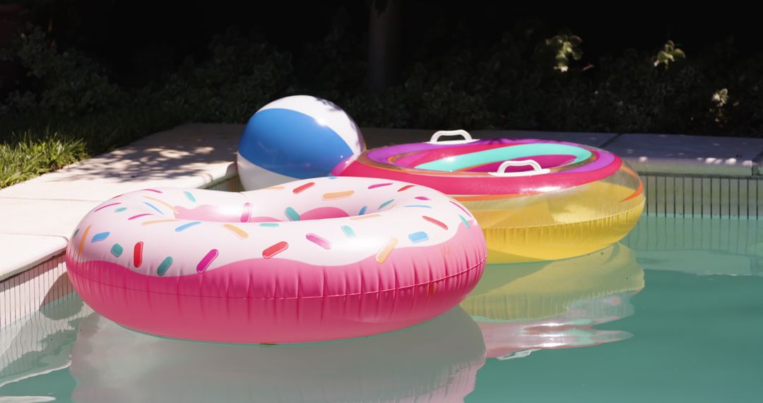 Colorful Inflatable Pool Toys Floating in Bright Turquoise Water