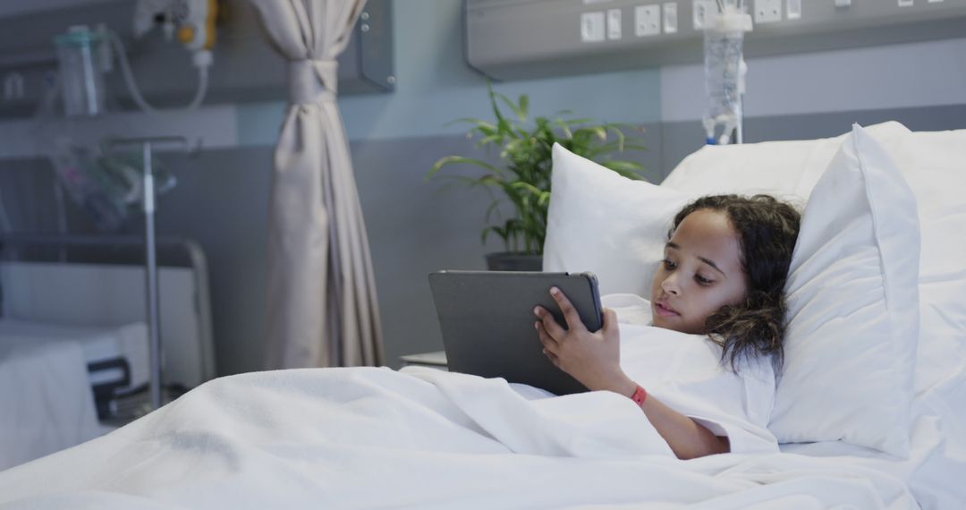 Young Girl Using Tablet While Lying in Hospital Bed - Free Images, Stock Photos and Pictures on Pikwizard.com