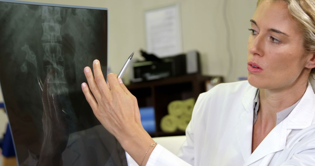 Female Doctor Analyzing X-Ray Image in Medical Office - Free Images, Stock Photos and Pictures on Pikwizard.com