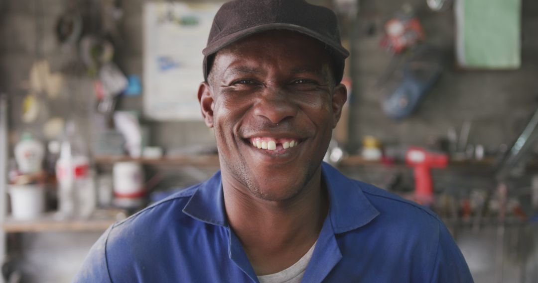 Smiling Mechanic in Workshop - Free Images, Stock Photos and Pictures on Pikwizard.com