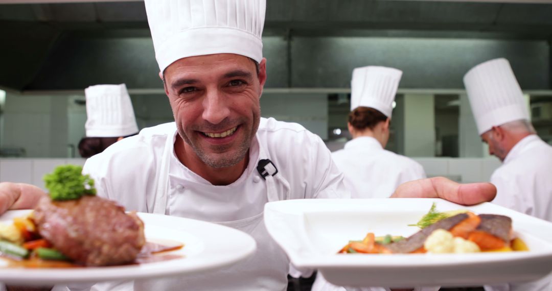 Smiling Chef Presenting Gourmet Dishes in Professional Kitchen
