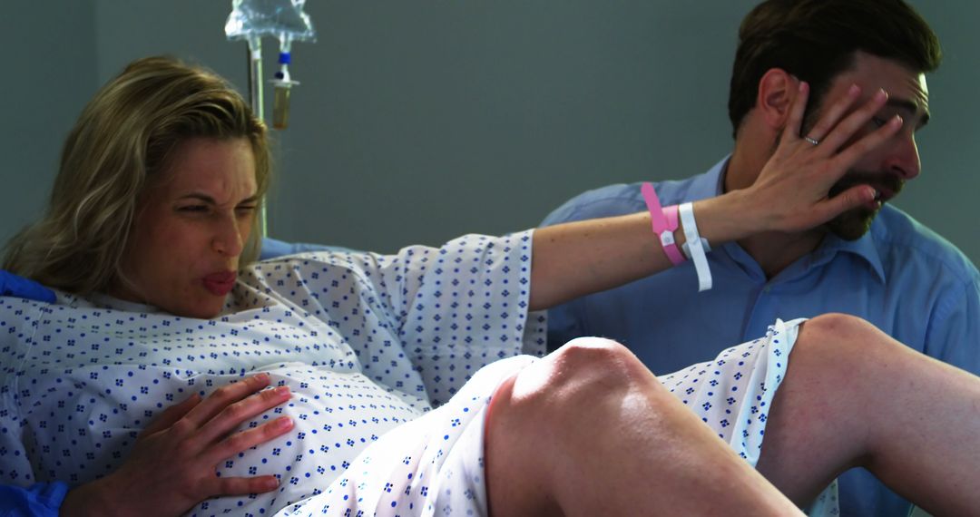 A couple endures the emotional intensity of childbirth in a hospital. - Free Images, Stock Photos and Pictures on Pikwizard.com