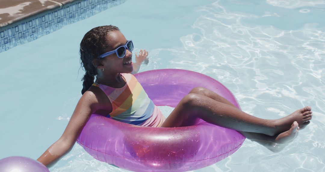 Young Girl Relaxing in Pool with Inflatable Ring on Sunny Day - Free Images, Stock Photos and Pictures on Pikwizard.com