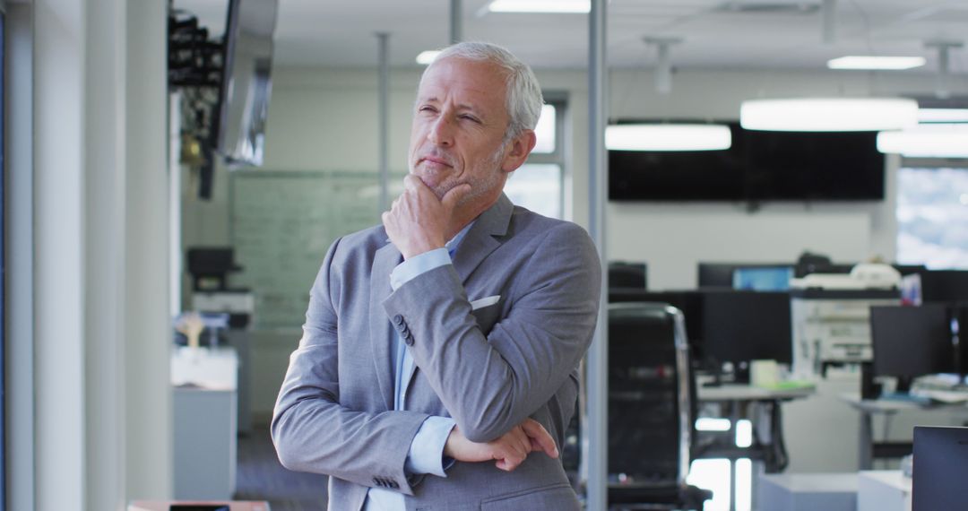 Businessman Pondering in Modern Office - Free Images, Stock Photos and Pictures on Pikwizard.com