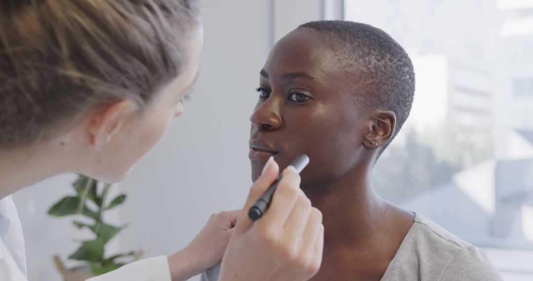 Dermatologist Examining African Woman's Skin in Clinic - Free Images, Stock Photos and Pictures on Pikwizard.com