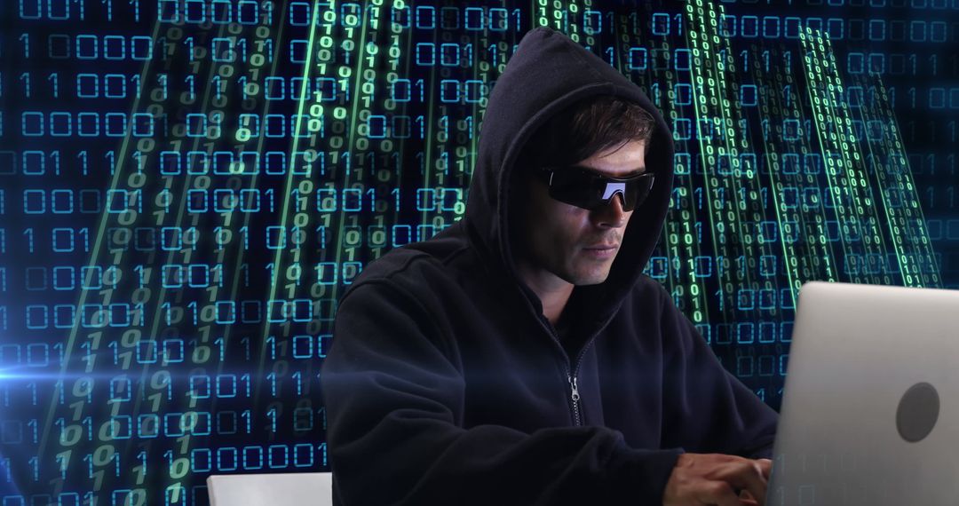 Hacker in Hoodie Working on Laptop with Digital Code Background