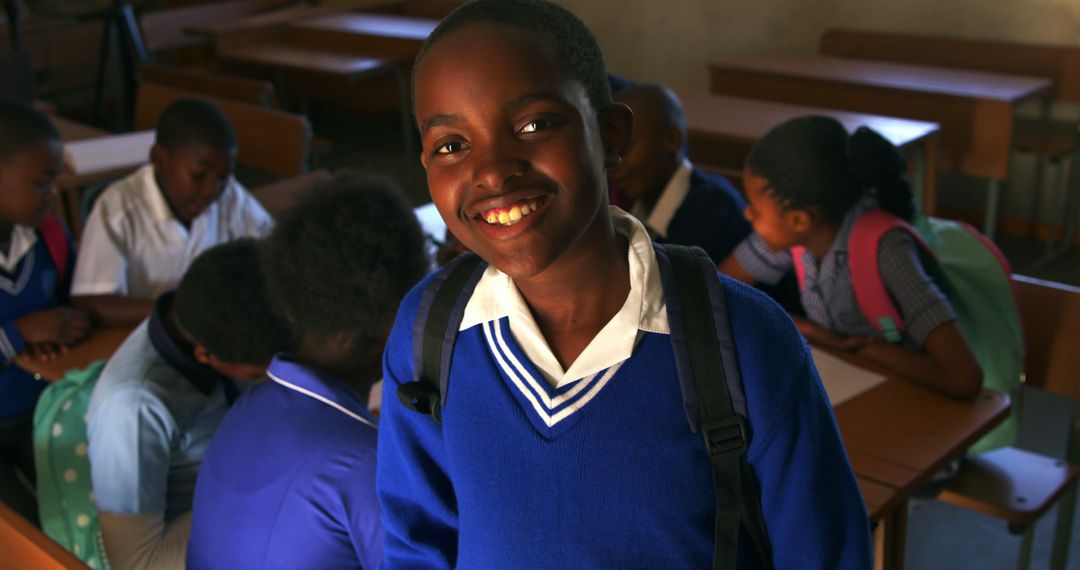 Smiling African Schoolboy in Blue Uniform with Classmates - Free Images, Stock Photos and Pictures on Pikwizard.com