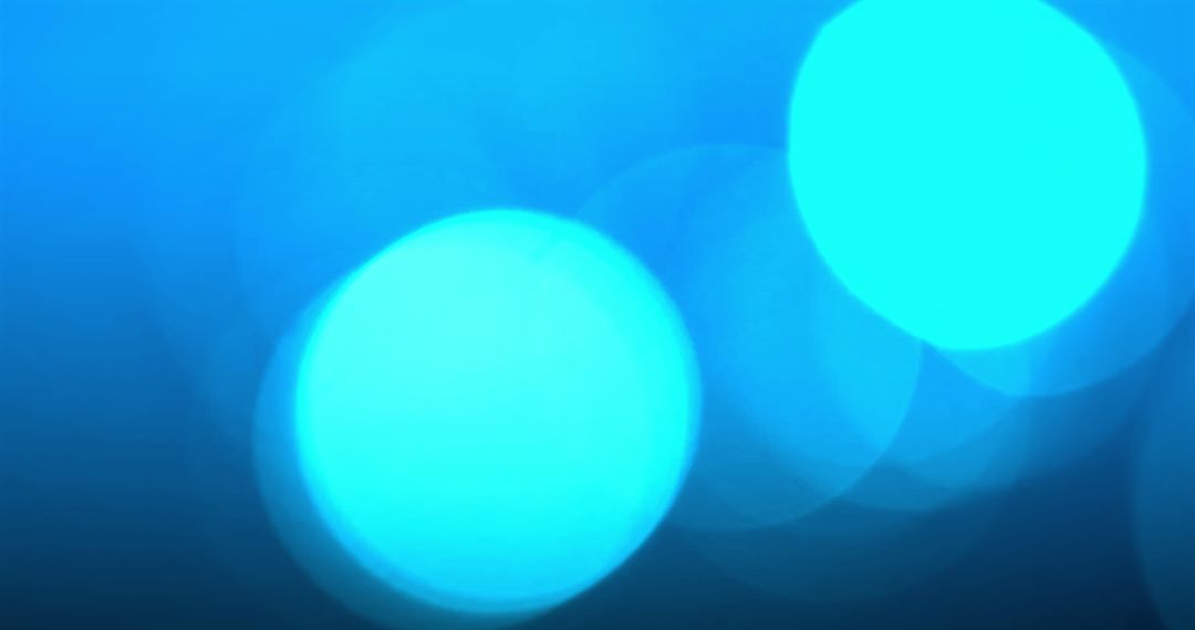 Blue Abstract Bokeh Lights and Falling Snowflakes