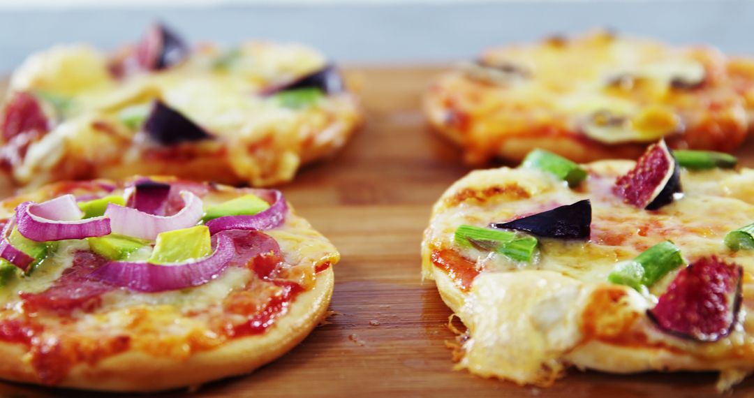 Close-up View of Freshly Baked Mini Pizzas with Various Toppings - Free Images, Stock Photos and Pictures on Pikwizard.com