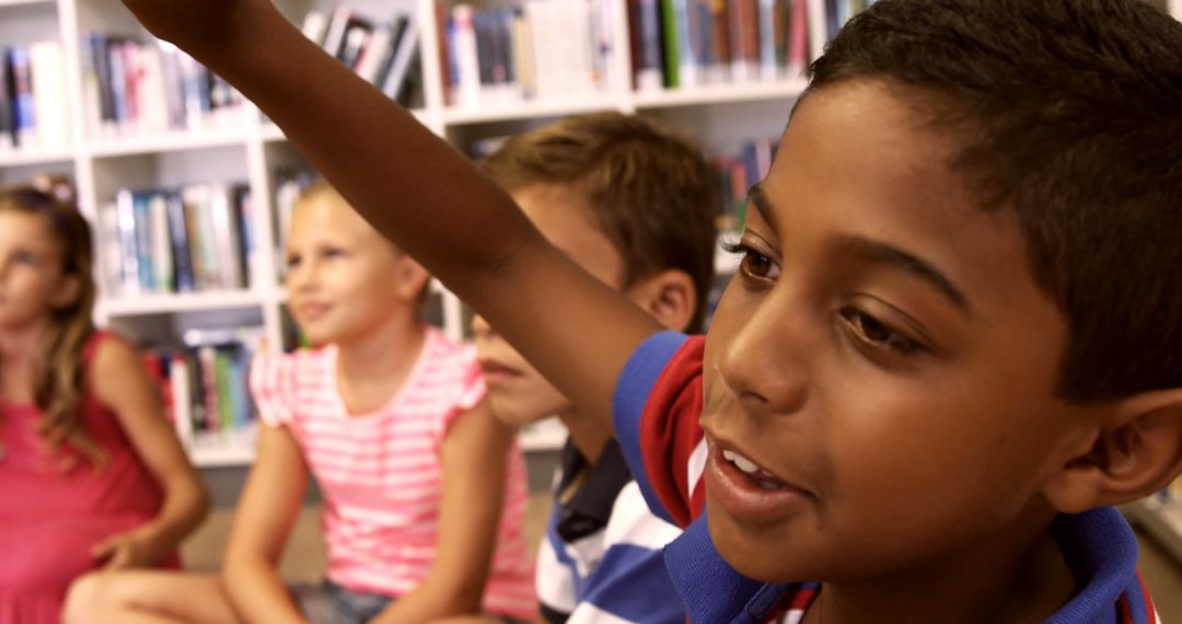 Young boy raising hand in classroom with friends - Free Images, Stock Photos and Pictures on Pikwizard.com