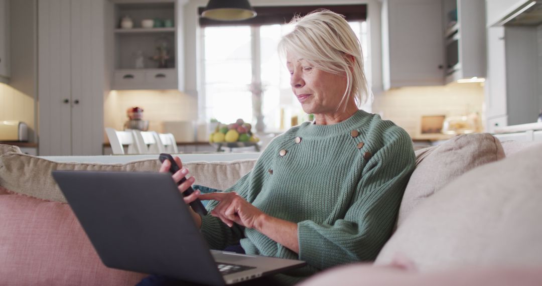 Senior Woman Using Smartphone and Laptop at Home - Free Images, Stock Photos and Pictures on Pikwizard.com