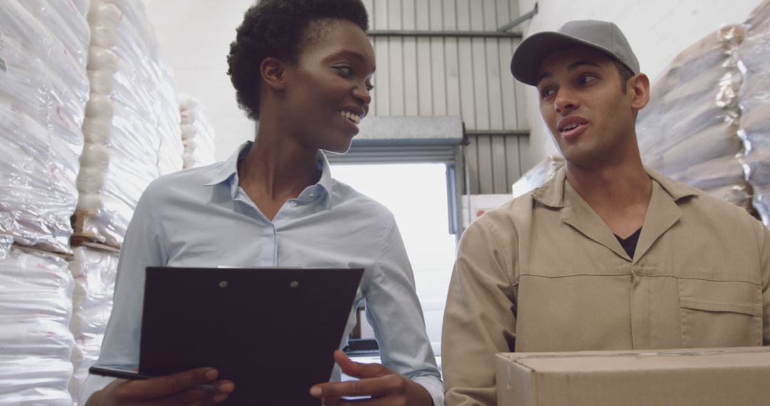 Diverse Workers Discussing Logistics in Warehouse - Free Images, Stock Photos and Pictures on Pikwizard.com