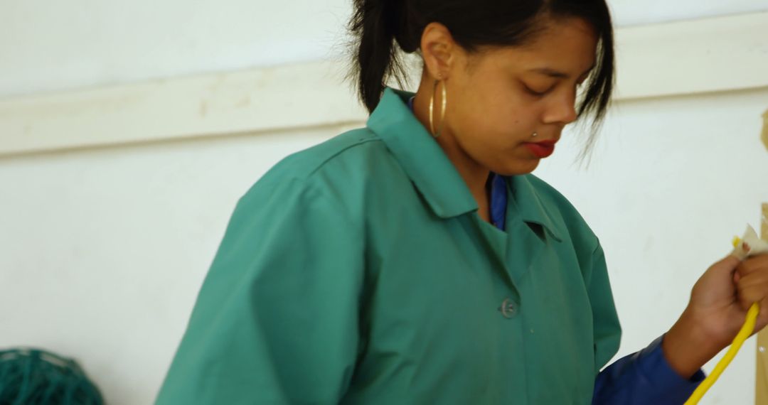 Woman Cleaning Floor with Broom in Green Uniform - Free Images, Stock Photos and Pictures on Pikwizard.com