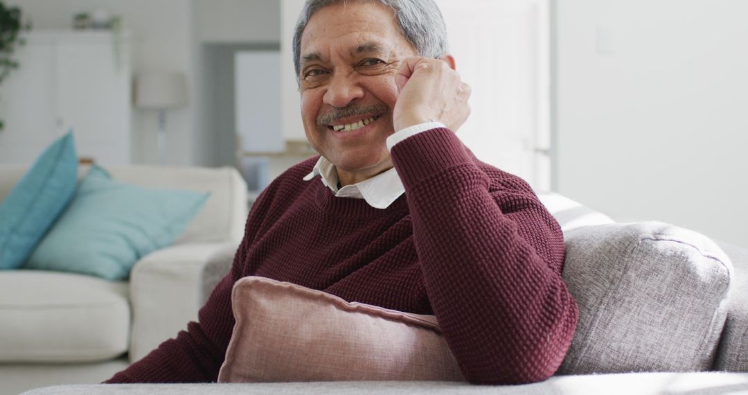 Elderly Man Relaxing On Sofa Smiling at Camera - Free Images, Stock Photos and Pictures on Pikwizard.com