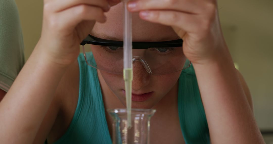 Young Scientist Conducting Experiment with Laboratory Equipment - Free Images, Stock Photos and Pictures on Pikwizard.com