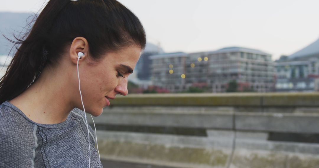 Woman Listening to Music While Jogging Outdoors - Free Images, Stock Photos and Pictures on Pikwizard.com