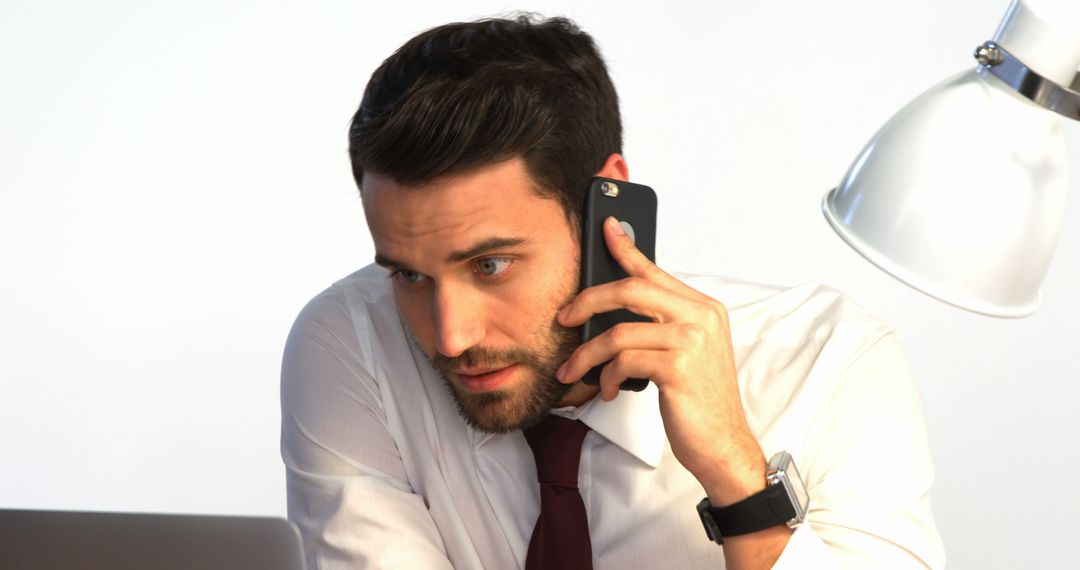 Professional Man Talking on Phone in Office Environment - Free Images, Stock Photos and Pictures on Pikwizard.com