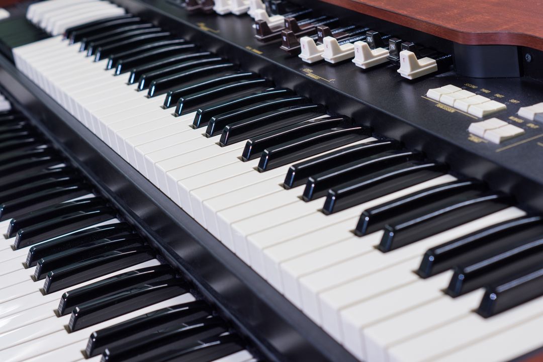 Close-up of Vintage organ keyboard with slider controls