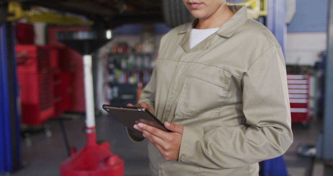 Mechanic Using Tablet in Auto Repair Garage - Free Images, Stock Photos and Pictures on Pikwizard.com