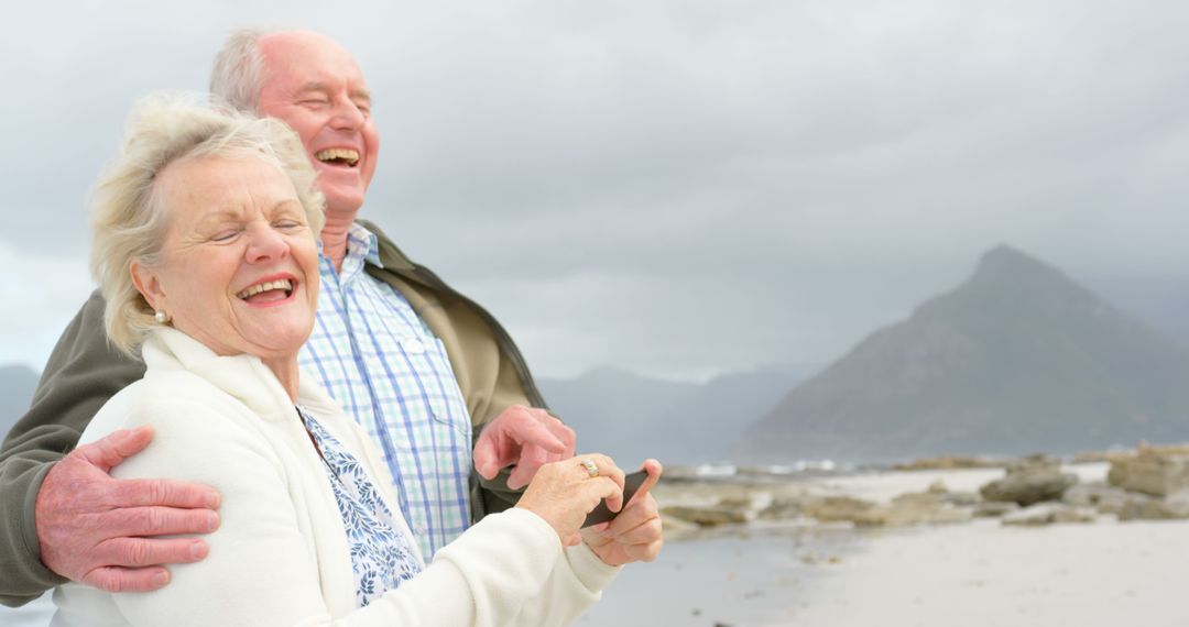 Happy Senior Couple Enjoying Day at the Beach - Free Images, Stock Photos and Pictures on Pikwizard.com