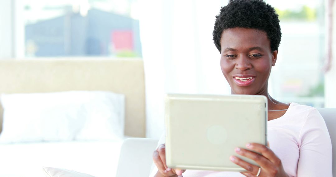 Cheerful African American Woman Using Tablet Computer at Home - Free Images, Stock Photos and Pictures on Pikwizard.com