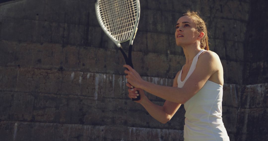 Young Woman Playing Tennis Outdoors Focusing On Game - Free Images, Stock Photos and Pictures on Pikwizard.com