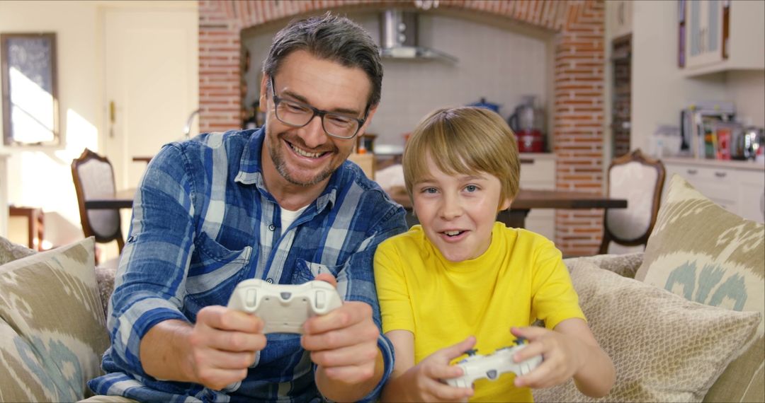 Father and Son Enjoying Video Games at Home - Free Images, Stock Photos and Pictures on Pikwizard.com