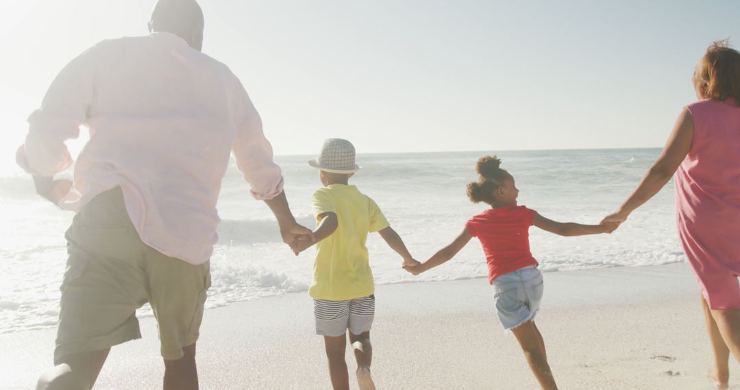 African American Family Holding Hands at Beach - Free Images, Stock Photos and Pictures on Pikwizard.com