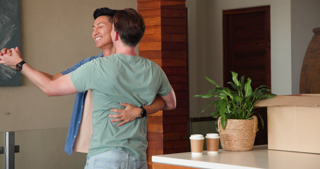 Diverse Gay Couple Dancing Happily in New Home