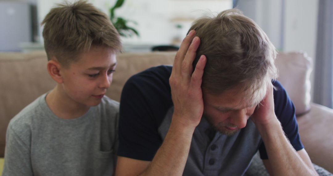 Worried Boy Comforting Stressed Father at Home - Free Images, Stock Photos and Pictures on Pikwizard.com