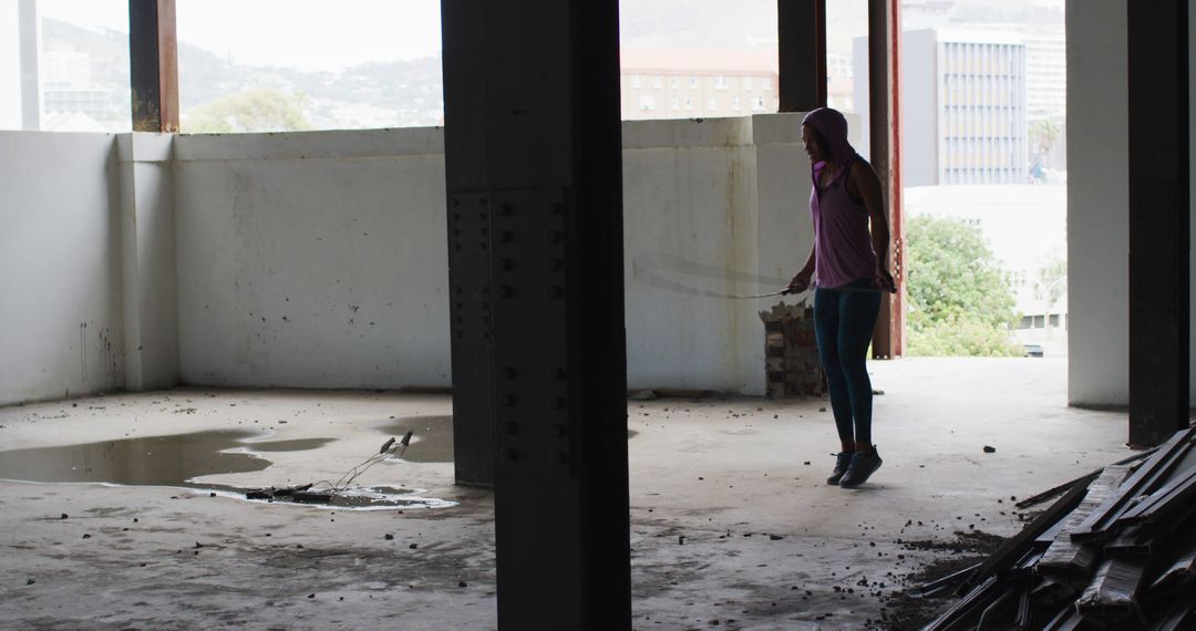 Person Exploring Derelict Building Interior with Wet Floor - Free Images, Stock Photos and Pictures on Pikwizard.com