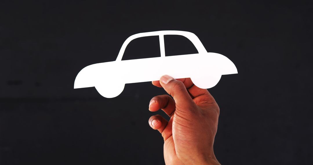 Hand Holding White Paper Cutout of Car Illustration Against Dark Background - Free Images, Stock Photos and Pictures on Pikwizard.com