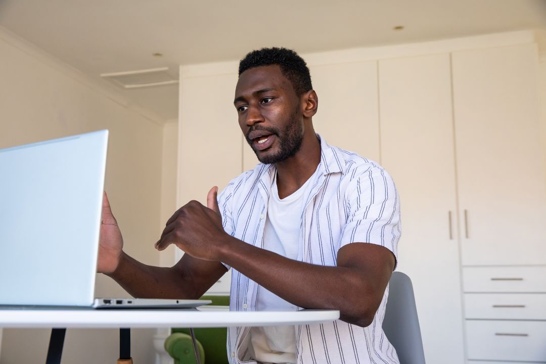Man Engaging in Online Meeting at Home Workspace