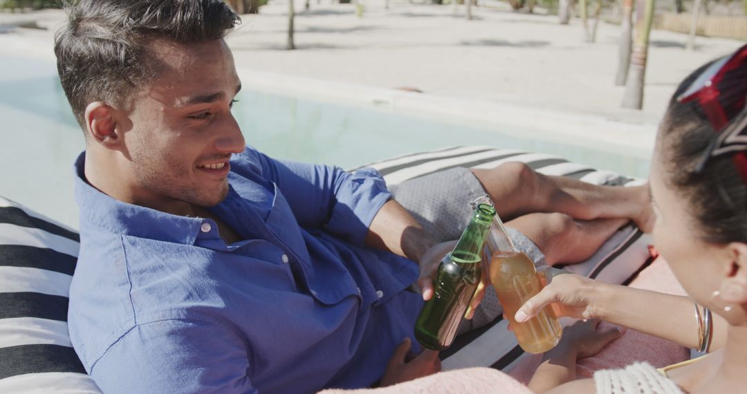 Couple Relaxing with Drinks by Poolside on a Tropical Vacation - Free Images, Stock Photos and Pictures on Pikwizard.com