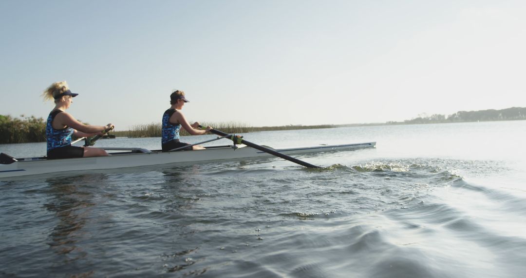 Women Rowing in Calm Lake during Day - Free Images, Stock Photos and Pictures on Pikwizard.com