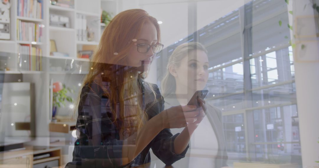 Professional Women Utilizing Smartphone for Business Tasks