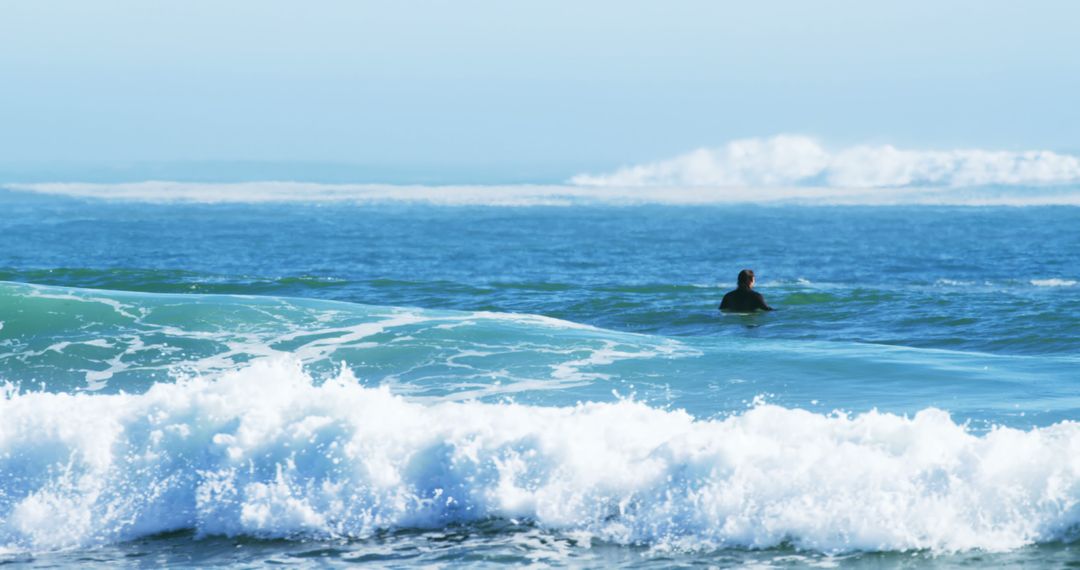 Surfer Waiting for Waves in Tranquil Ocean