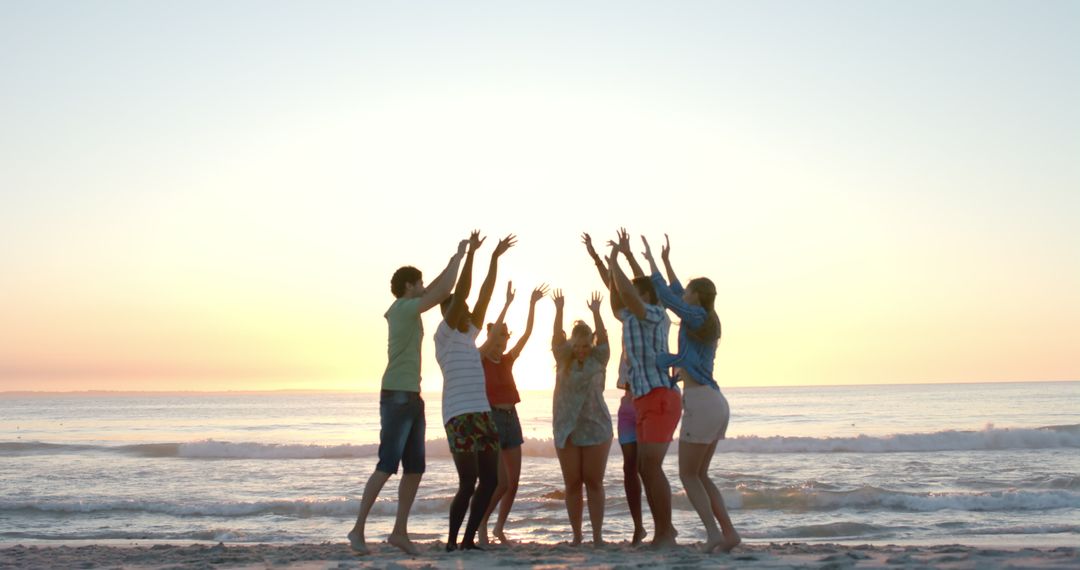 Diverse Friends Celebrating on Beach at Sunset