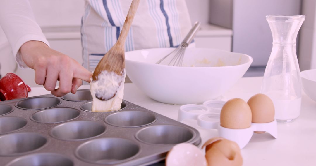 Baking at Home: Scooping Batter into Muffin Tray - Free Images, Stock Photos and Pictures on Pikwizard.com