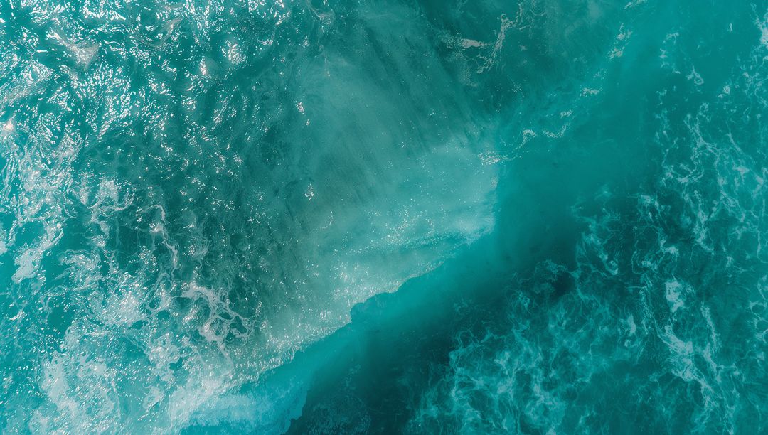 Aerial View Finedited's Blue Waves Dancing Over Deep Ocean Waters