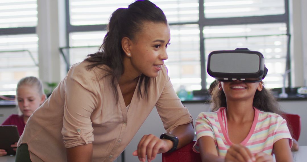 Teacher Assists Student Using Virtual Reality in Classroom - Free Images, Stock Photos and Pictures on Pikwizard.com