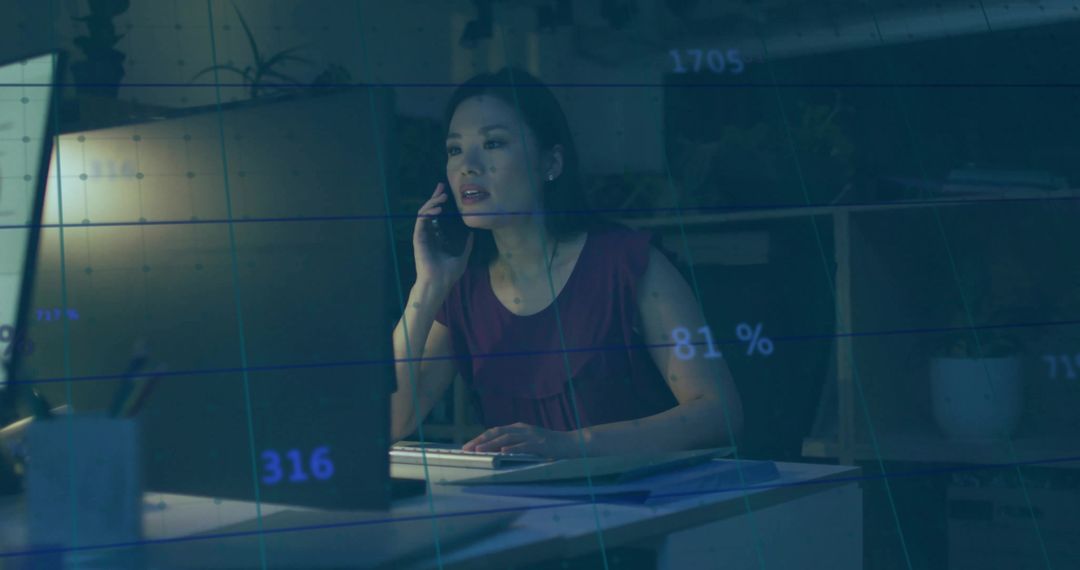 Asian Analyst Analyzing Data at Workplace Skyline Interface