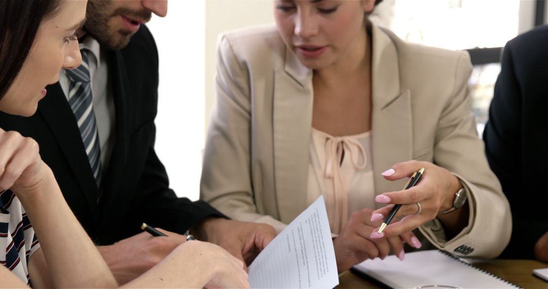 Corporate Team Discussing Business Strategies with Documents