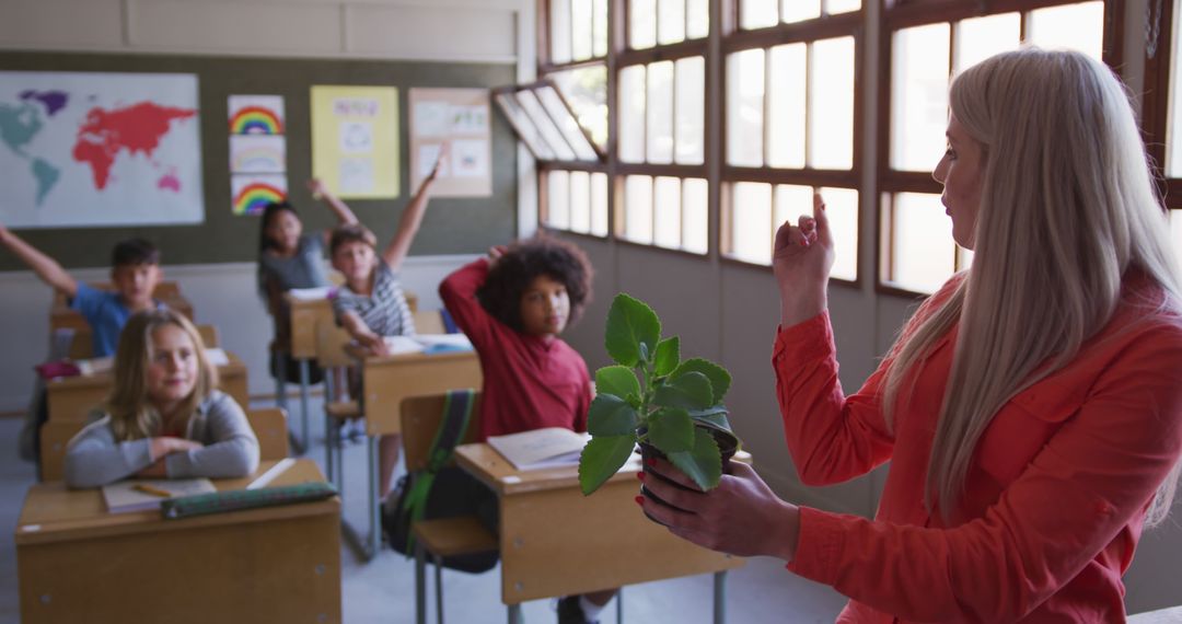 Teacher Discussing Plant with Attentive Students in Classroom - Free Images, Stock Photos and Pictures on Pikwizard.com