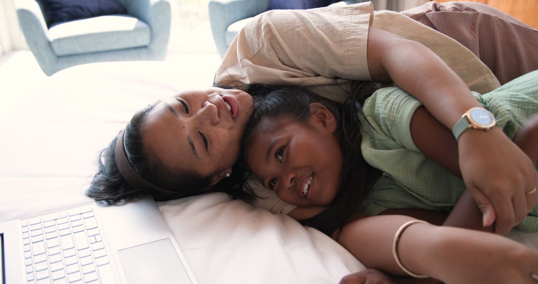 Mother and Daughter Hugging on Bed