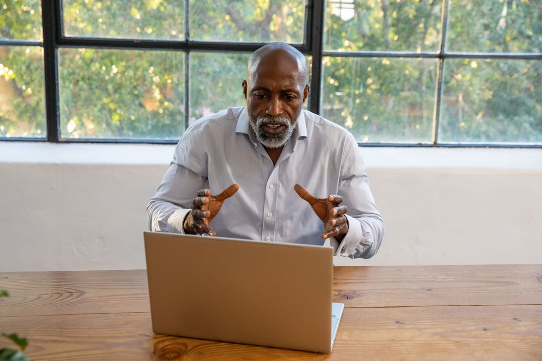 Professional Man Engaging in Remote Work by Office Window