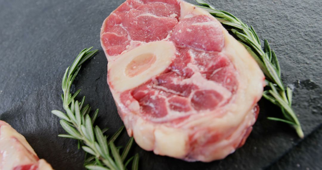 Raw Veal Osso Buco on Slate with Rosemary Garnish - Free Images, Stock Photos and Pictures on Pikwizard.com