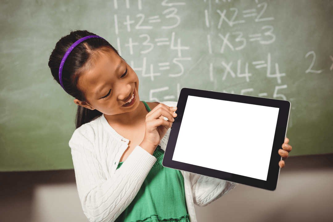Smiling Schoolgirl Displaying Blank Digital Tablet in Classroom