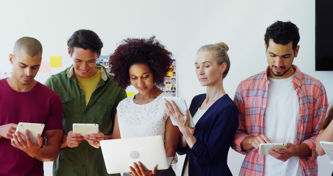 Diverse Group Engaging with Technology Devices