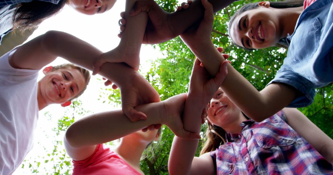 Diverse Friends Forming Unity Circle with Hands Outdoors - Free Images, Stock Photos and Pictures on Pikwizard.com